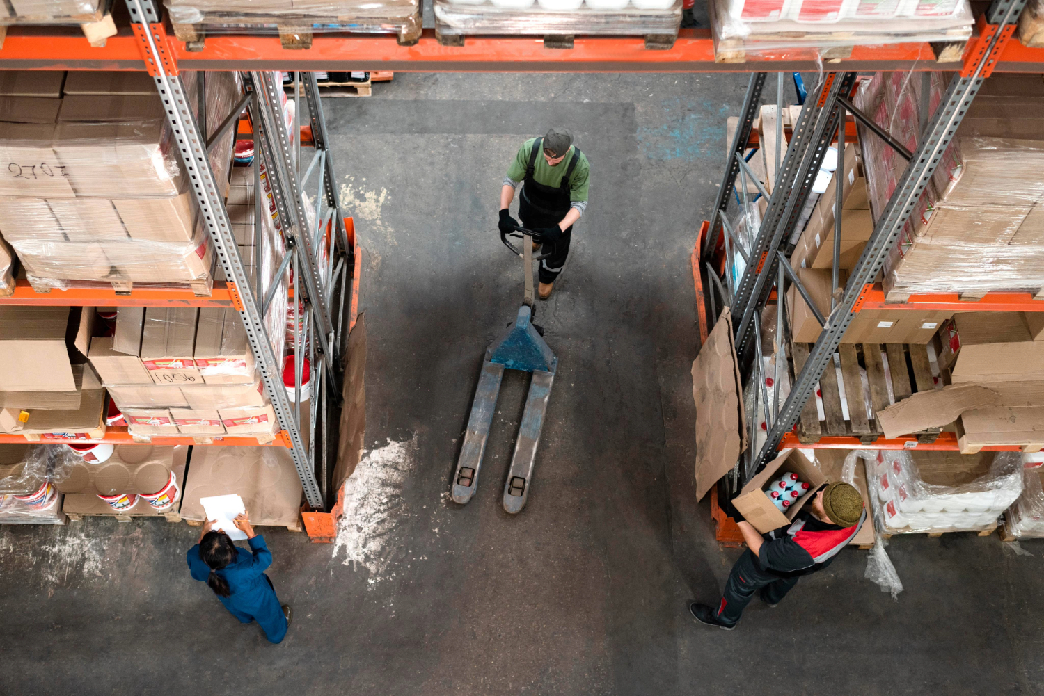 Workers working in a warehouse holding boxes.